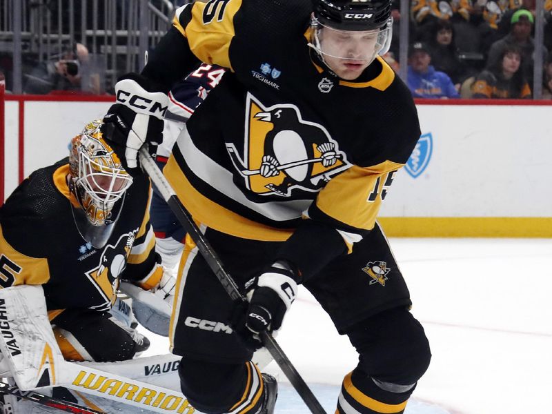 Mar 5, 2024; Pittsburgh, Pennsylvania, USA; Pittsburgh Penguins left wing Joona Koppanen (15) clears the puck against the Columbus Blue Jackets during the second period at PPG Paints Arena. The Penguins won 5-3. Mandatory Credit: Charles LeClaire-USA TODAY Sports