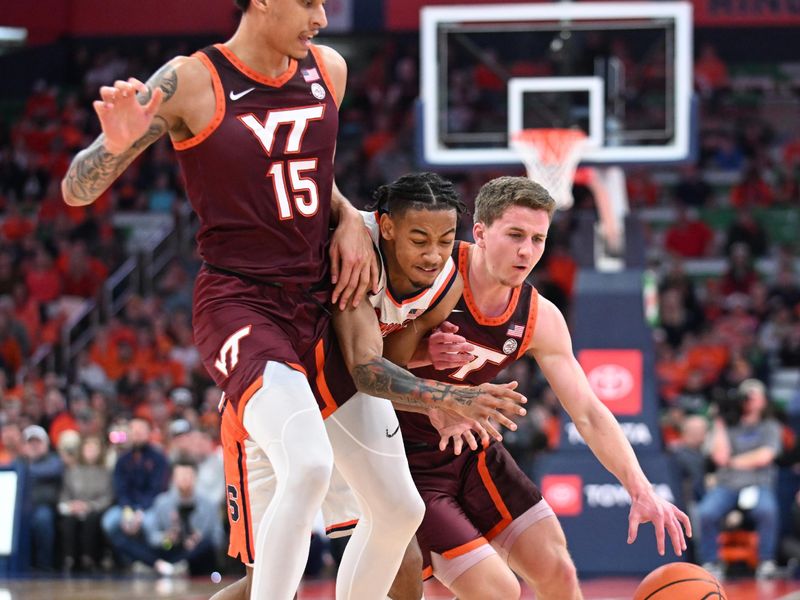 Feb 27, 2024; Syracuse, New York, USA; Syracuse Orange guard Judah Mintz (center) is pinched between Virginia Tech Hokies guard Sean Pedulla and center Lynn Kidd (15) in the first half at the JMA Wireless Dome. Mandatory Credit: Mark Konezny-USA TODAY Sports