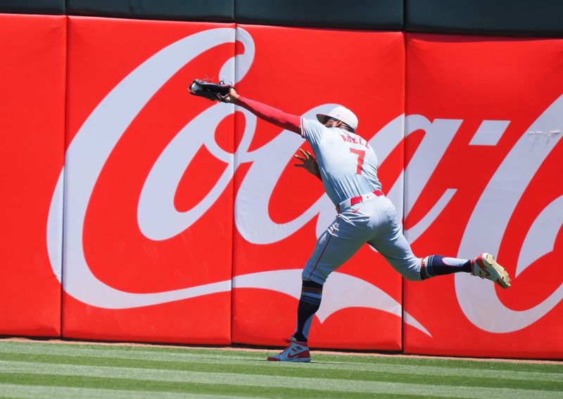 Jul 4, 2024; Oakland, California, USA; Los Angeles Angels right fielder Jo Adell (7) catches the ball against the Oakland Athletics during the third inning at Oakland-Alameda County Coliseum. Mandatory Credit: Kelley L Cox-USA TODAY Sports