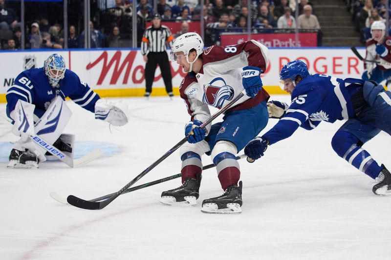 Jan 25, 2026; Toronto, Ontario, CAN; Colorado Avalanche forward Martin Necas (88) carries the puck around Toronto Maple Leafs defenseman Brandon Carlo (25) during the second period at Scotiabank Arena. Mandatory Credit: John E. Sokolowski-Imagn Images