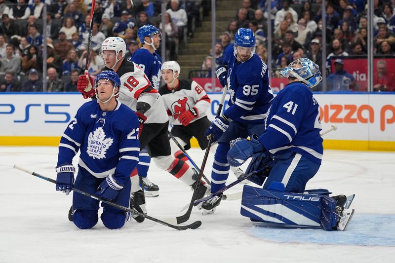 Oct 21, 2025; Toronto, Ontario, CAN; Toronto Maple Leafs goaltender Anthony Stolarz (41) and defenseman Jake McCabe (22) react after a goal by New Jersey Devils forward Cody Glass (not pictured) during the second period at Scotiabank Arena. Mandatory Credit: John E. Sokolowski-Imagn Images