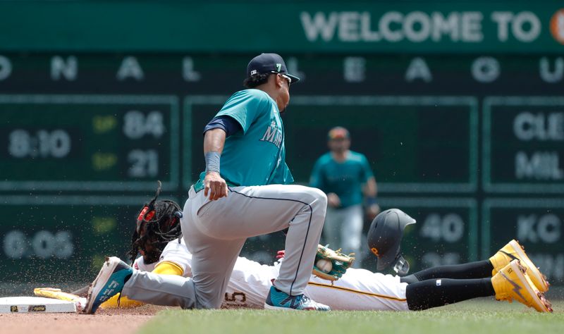 Aug 17, 2024; Pittsburgh, Pennsylvania, USA;  Pittsburgh Pirates designated hitter shortstop Oneil Cruz (15) steals second base as Seattle Mariners shortstop Leo Rivas (76) applies a late tag during the fourth inning at PNC Park. Mandatory Credit: Charles LeClaire-USA TODAY Sports