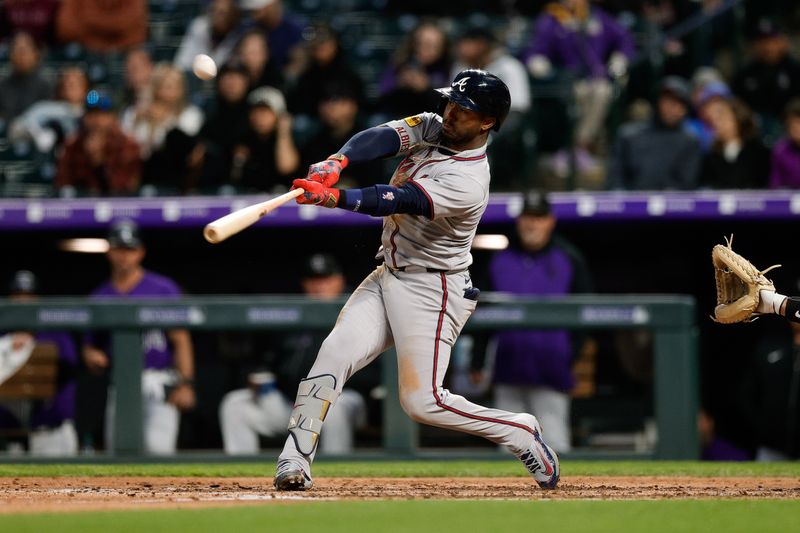 Apr 28, 2025; Denver, Colorado, USA; Atlanta Braves second baseman Ozzie Albies (1) hits a single in the fifth inning against the Colorado Rockies at Coors Field. Mandatory Credit: Isaiah J. Downing-Imagn Images