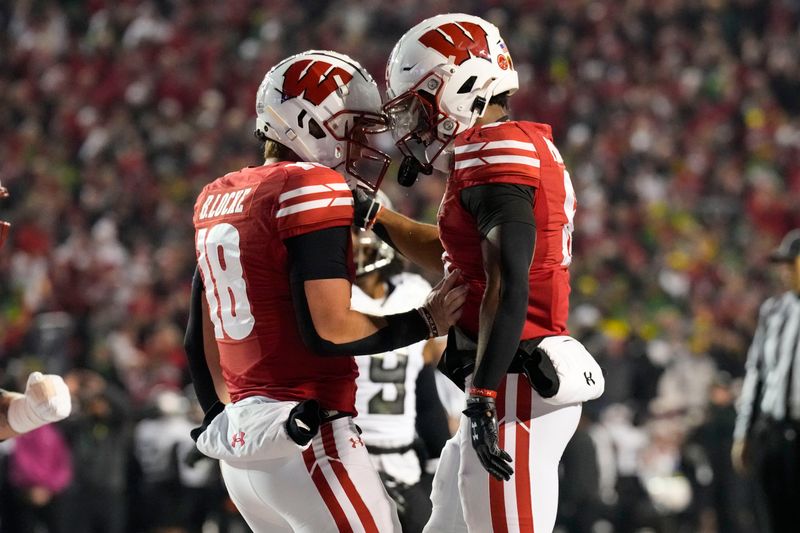 Nov 16, 2024; Madison, Wisconsin, USA;  Wisconsin Badgers wide receiver Will Pauling (6) celebrates with quarterback Braedyn Locke (18)  after scoring a touchdown during the second quarter against the Oregon Ducks at Camp Randall Stadium. Mandatory Credit: Jeff Hanisch-Imagn Images