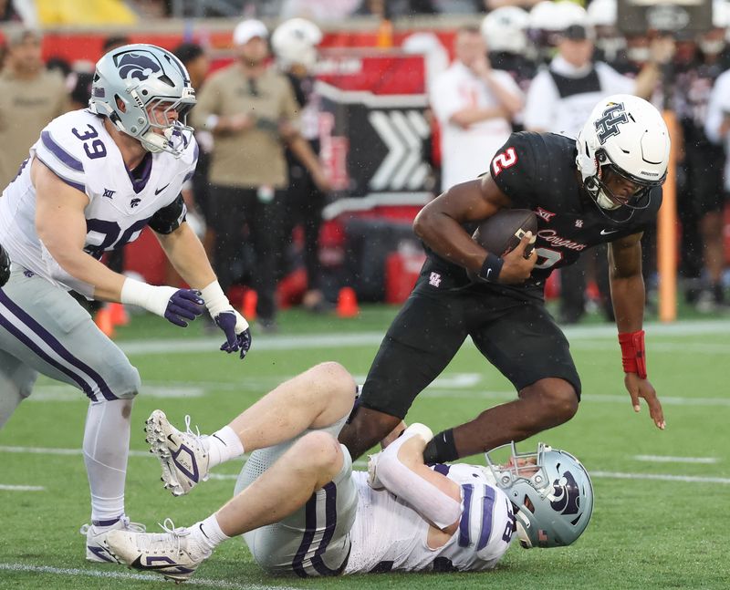 Nov 2, 2024; Houston, Texas, USA; Houston Cougars quarterback Zeon Chriss (2) is tackled by Kansas State Wildcats defensive end Brendan Mott (38) in the first quarter at TDECU Stadium. Mandatory Credit: Thomas B. Shea-Imagn Images