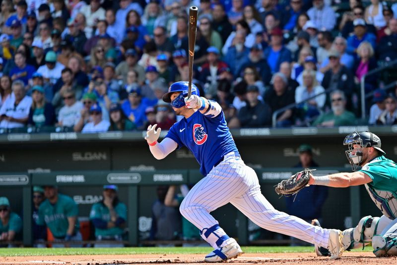 Mar 8, 2024; Mesa, Arizona, USA;  Chicago Cubs right fielder Seiya Suzuki (27) singles in the first inning against the Seattle Mariners during a spring training game at Sloan Park. Mandatory Credit: Matt Kartozian-USA TODAY Sports