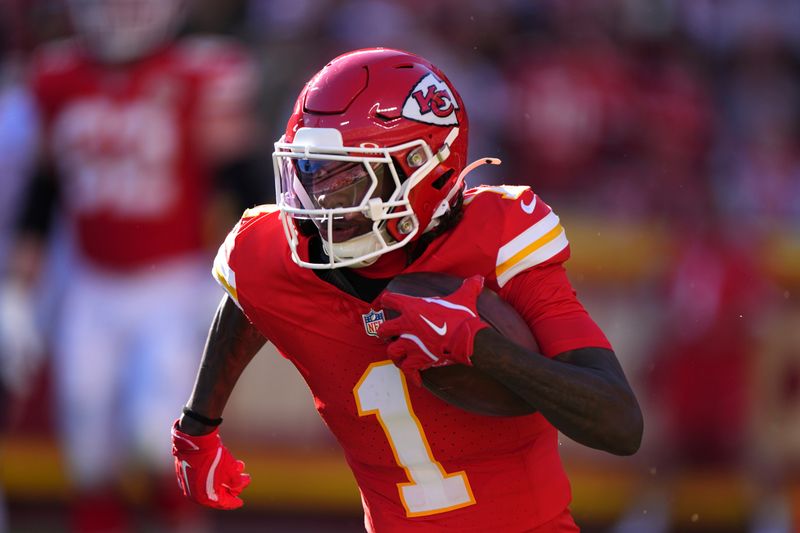 Kansas City Chiefs wide receiver Xavier Worthy (1) runs with the ball during the second half of an NFL football game against the Denver Broncos Sunday, Nov. 10, 2024, in Kansas City, Mo. (AP Photo/Charlie Riedel)