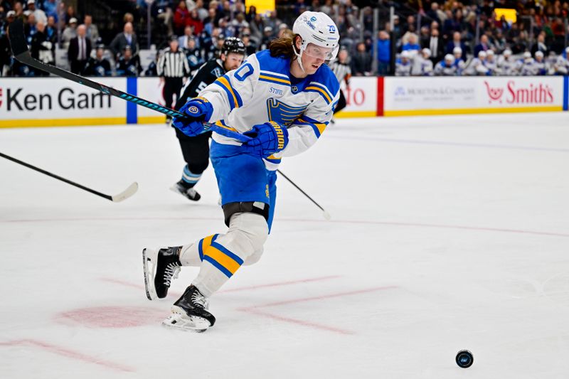 Jan 9, 2026; Salt Lake City, Utah, USA; St. Louis Blues center Oskar Sundqvist (70) clears out the puck during second period against the Utah Mammoth at Delta Center. Mandatory Credit: Peter Creveling-Imagn Images