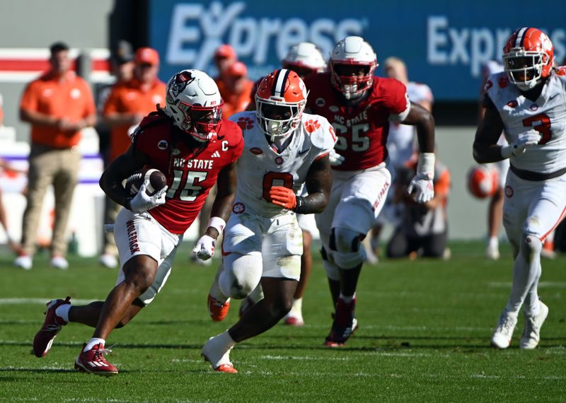 Oct 28, 2023; Raleigh, North Carolina, USA; North Carolina State Wolfpack wide receiver Keyon Lesane (15) runs after a catch as Clemson Tigers linebacker Barrett Carter (0) defends during the first half at Carter-Finley Stadium. Mandatory Credit: Rob Kinnan-USA TODAY Sports