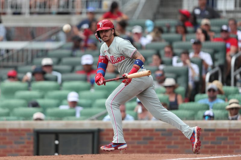 Jun 29, 2025; Cumberland, Georgia, Philadelphia Phillies second baseman Bryson Stott (5) hits a foul ball during a game against the Atlanta Braves during the ninth inning at Truist Park. Mandatory Credit: Mady Mertens-Imagn Images