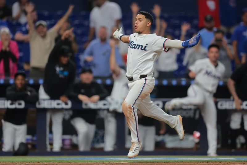 May 19, 2025; Miami, Florida, USA; Miami Marlins shortstop Javier Sanoja (46) reacts as he runs toward home plate to score against the Chicago Cubs during the ninth inning at loanDepot Park. Mandatory Credit: Sam Navarro-Imagn Images