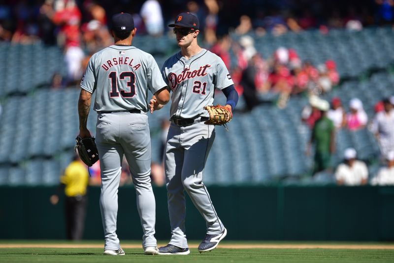 Jun 27, 2024; Anaheim, California, USA; Detroit Tigers first baseman Gio Urshela (13) and outfielder Mark Canha (21) celebrate the victory against the Los Angeles Angels at Angel Stadium. Mandatory Credit: Gary A. Vasquez-USA TODAY Sports