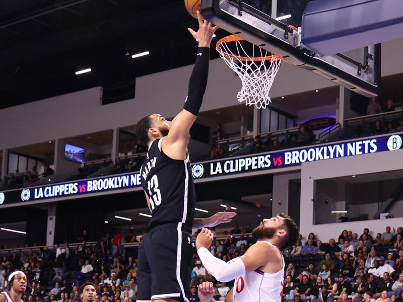 OCEANSIDE, CALIFORNIA - OCTOBER 08: Shake Milton #13 of the Brooklyn Nets lays up a shot over Nate Darling #30 of the Los Angeles Clippers in the fourth quarter at Frontwave Arena on October 08, 2024 in Oceanside, California. NOTE TO USER: User expressly acknowledges and agrees that, by downloading and or using this photograph, User is consenting to the terms and conditions of the Getty Images License Agreement. (Photo by Joe Scarnici/Getty Images)