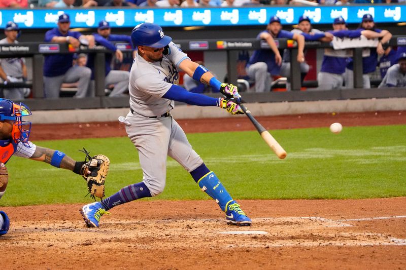 Jul 16, 2023; New York City, New York, USA; Los Angeles Dodgers shortstop Miguel Rojas (11) hits a single against the New York Mets during the eighth inning at Citi Field. Mandatory Credit: Gregory Fisher-USA TODAY Sports