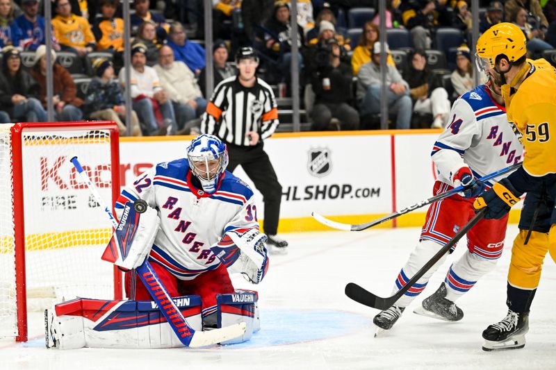 Dec 21, 2025; Nashville, Tennessee, USA;  New York Rangers goaltender Jonathan Quick (32) blocks the shot of Nashville Predators defenseman Roman Josi (59) during the third period at Bridgestone Arena. Mandatory Credit: Steve Roberts-Imagn Images