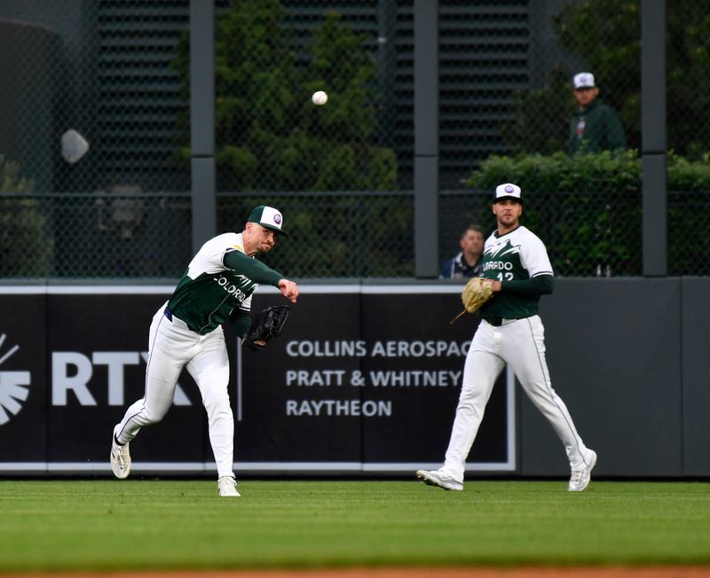 May 11, 2024; Denver, Colorado, USA; Colorado Rockies outfielder Brenton Doyle (9) makes a throw to home plate after catching a fly ball for an out against the Texas Rangers during the fifth inning at Coors Field. Mandatory Credit: John Leyba-USA TODAY Sports