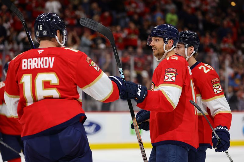 Nov 14, 2024; Sunrise, Florida, USA; Florida Panthers center Sam Reinhart (13) celebrates with center Aleksander Barkov (16) after scoring against the New Jersey Devils during the second period at Amerant Bank Arena. Mandatory Credit: Sam Navarro-Imagn Images