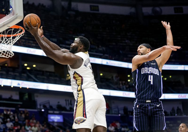 NEW ORLEANS, LOUISIANA - OCTOBER 7:  Zion Williamson #1 of the New Orleans Pelicans shoots past Jalen Suggs #4 of the Orlando Magic during the first half of a preseason game at the Smoothie King Center on October 7, 2024 in New Orleans, Louisiana. NOTE TO USER: User expressly acknowledges and agrees that, by downloading and or using this photograph, User is consenting to the terms and conditions of the Getty Images License Agreement. (Photo by Derick E. Hingle/Getty Images)