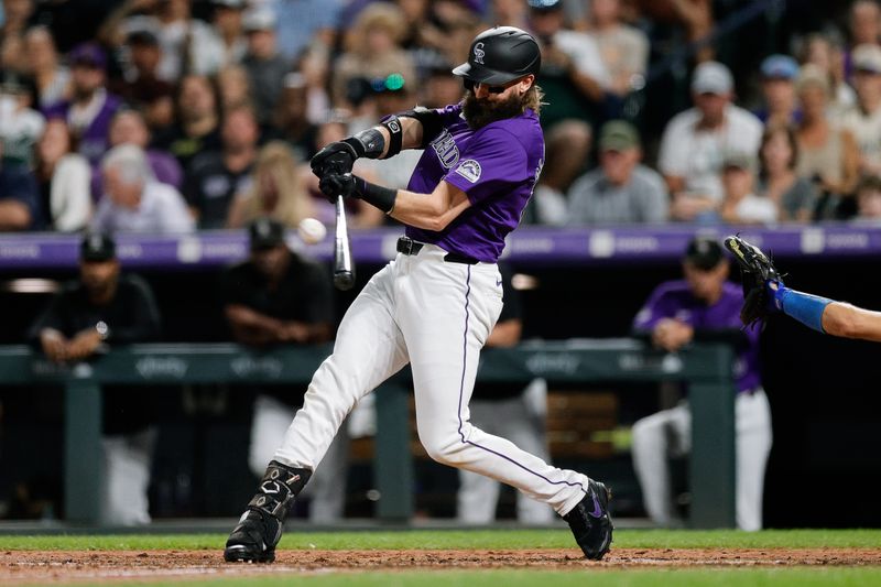 Sep 27, 2024; Denver, Colorado, USA; Colorado Rockies designated hitter Charlie Blackmon (19) this a single in the fifth inning against the Los Angeles Dodgers at Coors Field. Mandatory Credit: Isaiah J. Downing-Imagn Images