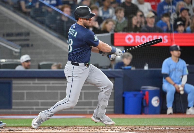 Apr 20, 2025; Toronto, Ontario, CAN;  Seattle Mariners catcher Mitch Garver (18) hits an RBI single against the Toronto Blue Jays in the second inning at Rogers Centre. Mandatory Credit: Dan Hamilton-Imagn Images