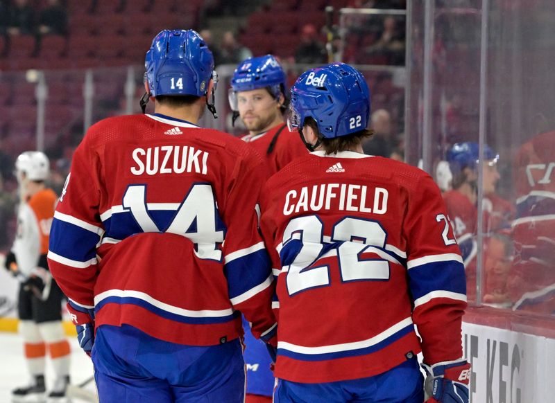 Apr 9, 2024; Montreal, Quebec, CAN; Montreal Canadiens forward Nick Suzuki (14) and teammate Cole Caufield (22) skate towards Montreal Canadiens forward Josh Anderson during the warmup period before the game against the Philadelphia Flyers at the Bell Centre. Mandatory Credit: Eric Bolte-USA TODAY Sports