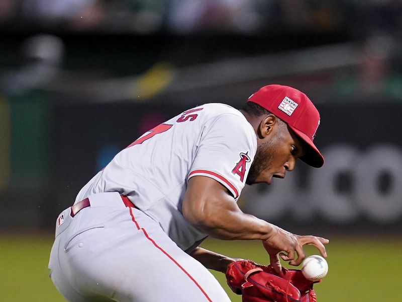 Jul 19, 2024; Oakland, California, USA; Los Angeles Angels pitcher Roansy Contreras (57) fields a ground ball before making a throw to first to record an out against the Oakland Athletics in the sixth inning at Oakland-Alameda County Coliseum. Mandatory Credit: Cary Edmondson-USA TODAY Sports