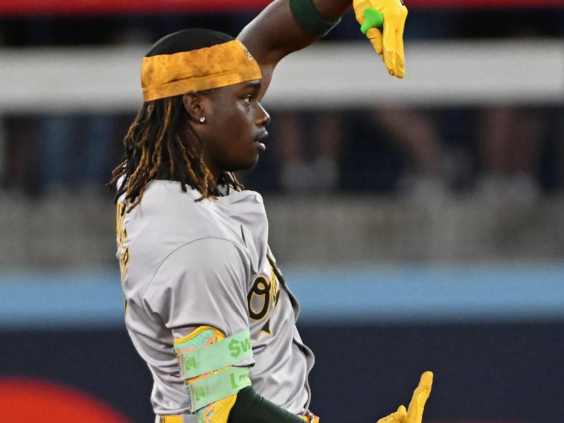 Aug 11, 2024; Toronto, Ontario, CAN; Oakland Athletics right field Lawrence Butler (4) celebrates a double in the first inning against the Toronto Blue Jays at Rogers Centre. Mandatory Credit: Gerry Angus-USA TODAY Sports