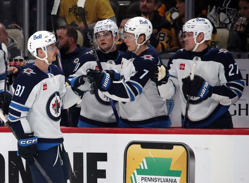 Nov 22, 2024; Pittsburgh, Pennsylvania, USA; Winnipeg Jets left wing Kyle Connor (81) celebrates his empty net goal with the Jets bench against the Pittsburgh Penguins during the third period at PPG Paints Arena. Mandatory Credit: Charles LeClaire-Imagn Images