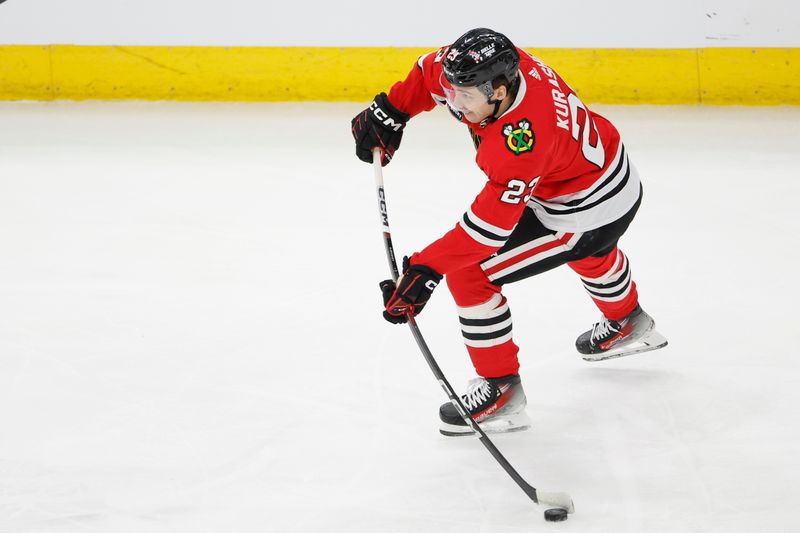 Feb 23, 2024; Chicago, Illinois, USA; Chicago Blackhawks center Philipp Kurashev (23) looks to pass the puck against the Winnipeg Jets during the first period at United Center. Mandatory Credit: Kamil Krzaczynski-USA TODAY Sports