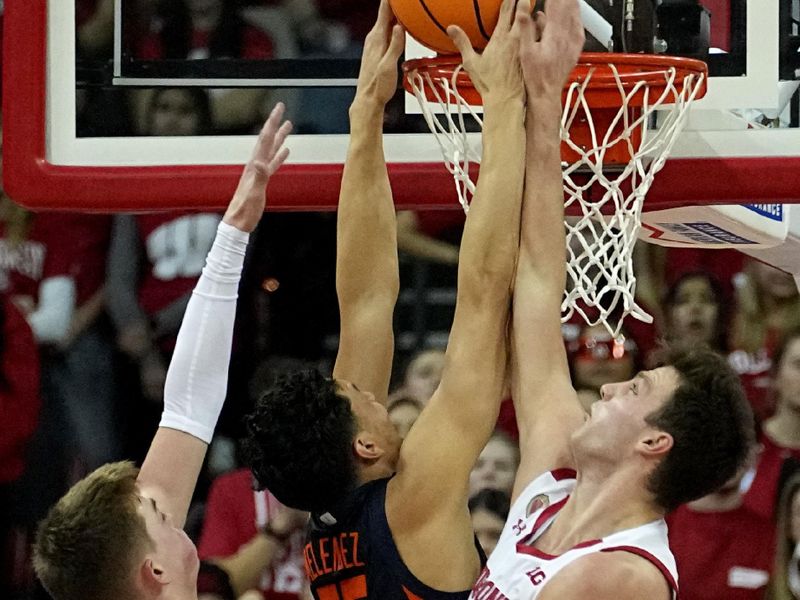 Jan 1, 2023; Madison, Wis, USA; Illinois guard RJ Melendez (15) scores on Wisconsin guard Connor Essegian (3) and forward Carter Gilmore (14) during the second half of their game at the Kohl Center. Mandatory Credit: Mark Hoffman/Milwaukee Journal Sentinel via USA TODAY NETWORK