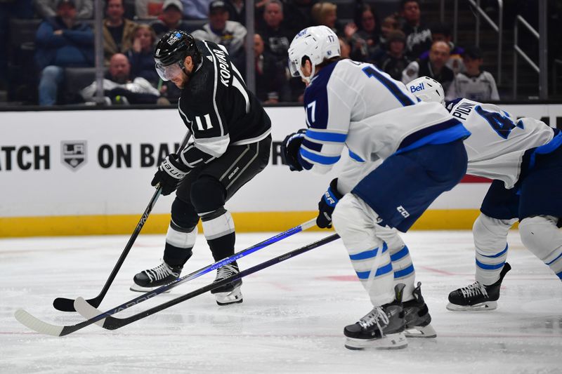 Dec 13, 2023; Los Angeles, California, USA; Los Angeles Kings center Anze Kopitar (11) moves in for a shot against the Winnipeg Jets during the second period at Crypto.com Arena. Mandatory Credit: Gary A. Vasquez-USA TODAY Sports