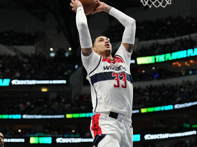 DALLAS, TX - FEBRUARY 12: Kyle Kuzma #33 of the Washington Wizards drives to the basket during the game against the Dallas Mavericks on February 12, 2024 at the American Airlines Center in Dallas, Texas. NOTE TO USER: User expressly acknowledges and agrees that, by downloading and or using this photograph, User is consenting to the terms and conditions of the Getty Images License Agreement. Mandatory Copyright Notice: Copyright 2024 NBAE (Photo by Glenn James/NBAE via Getty Images)