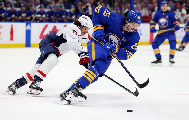 Apr 11, 2024; Buffalo, New York, USA;  Buffalo Sabres defenseman Owen Power (25) controls the puck as Washington Capitals left wing Sonny Milano (15) tries to defend during the third period at KeyBank Center. Mandatory Credit: Timothy T. Ludwig-USA TODAY Sports