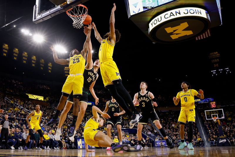 Feb 25, 2024; Ann Arbor, Michigan, USA;  Michigan Wolverines guard Jace Howard (25) Purdue Boilermakers center Zach Edey (15) and forward Tray Jackson (2) go for the rebound in the second half at Crisler Center. Mandatory Credit: Rick Osentoski-USA TODAY Sports