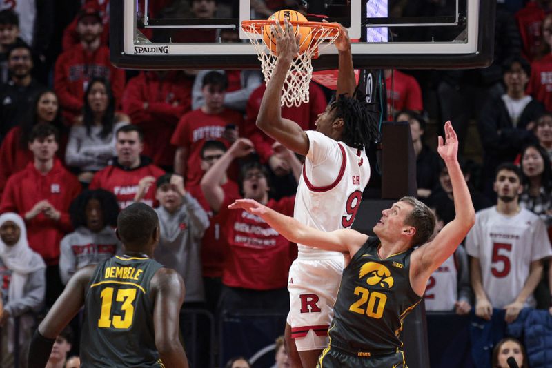 Feb 12, 2025; Piscataway, New Jersey, USA; Rutgers Scarlet Knights forward Dylan Grant (9) dunks the ball during the first half against Iowa Hawkeyes forward Payton Sandfort (20) at Jersey Mike's Arena. Mandatory Credit: Vincent Carchietta-Imagn Images