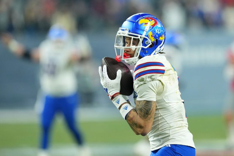 Dec 26, 2023; Phoenix, AZ, USA; Kansas Jayhawks wide receiver Lawrence Arnold (2) catches a pass and scores a touchdown against the UNLV Rebels during the second half at Chase Field. Mandatory Credit: Joe Camporeale-USA TODAY Sports