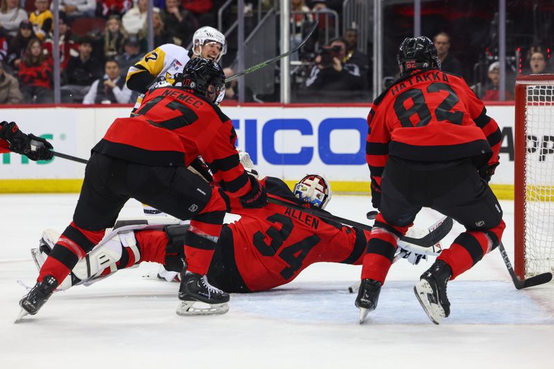 Mar 19, 2024; Newark, New Jersey, USA; New Jersey Devils goaltender Jake Allen (34) makes a save on Pittsburgh Penguins center Sidney Crosby (87) during the first period at Prudential Center. Mandatory Credit: Ed Mulholland-USA TODAY Sports