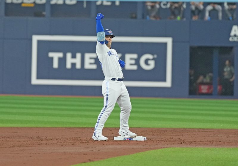 Jun 28, 2023; Toronto, Ontario, CAN; Toronto Blue Jays center fielder Daulton Varsho (25) celebrates hitting an RBI double against the San Francisco Giants during the first inning at Rogers Centre. Mandatory Credit: Nick Turchiaro-USA TODAY Sports