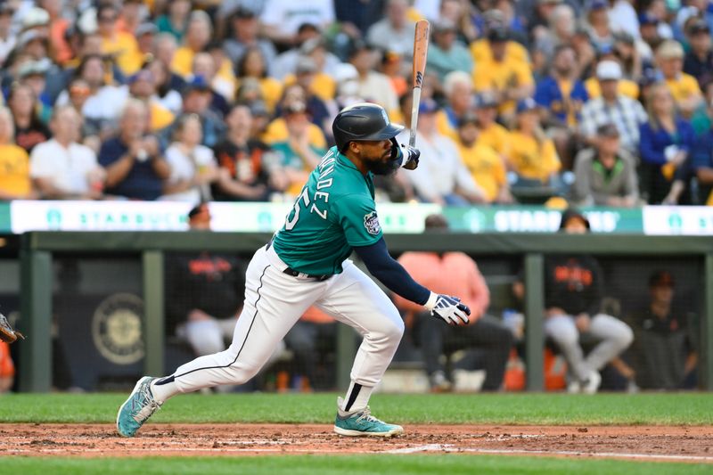 Aug 12, 2023; Seattle, Washington, USA; Seattle Mariners right fielder Teoscar Hernandez (35) hits a single against the Baltimore Orioles during the fourth inning at T-Mobile Park. Mandatory Credit: Steven Bisig-USA TODAY Sports