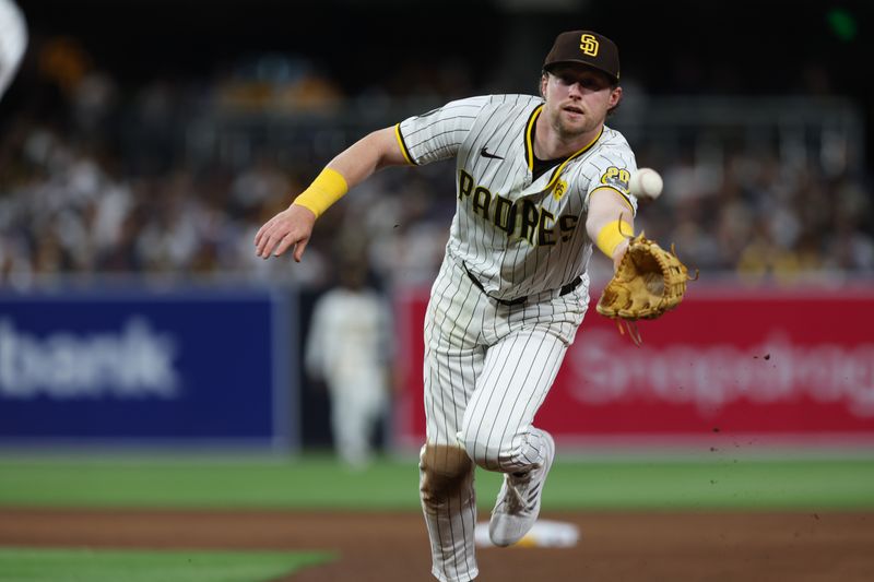 May 25, 2024; San Diego, California, USA; San Diego Padres second baseman Jake Cronenworth (9) flips the ball to first baseman Luis Arraez (4) during the fifth inning at Petco Park. Mandatory Credit: Chadd Cady-USA TODAY Sports