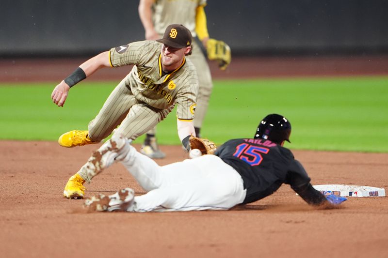 Jun 14, 2024; New York City, New York, USA; San Diego Padres second baseman Jake Cronenworth (9) tags out New York Mets center fielder Tyrone Taylor (15) attempting to steal second base during the fourth inning at Citi Field. Mandatory Credit: Gregory Fisher-USA TODAY Sports