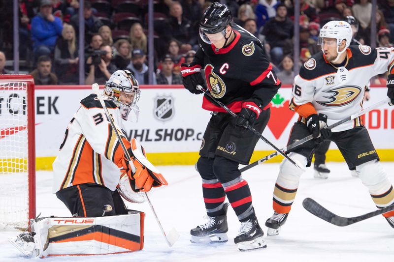 Feb 15, 2024; Ottawa, Ontario, CAN; Anaheim Ducks goalie John Gibson (36) makes a save in front of Ottawa Senators left wing Brady Tkachuk (7) in the first period at the Canadian Tireof Centre. Mandatory Credit: Marc DesRosiers-USA TODAY Sports