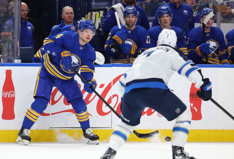 Dec 1, 2025; Buffalo, New York, USA;  Buffalo Sabres defenseman Bowen Byram (4) clears the puck as Winnipeg Jets center Vladislav Namestnikov (7) defends during the second period at KeyBank Center. Mandatory Credit: Timothy T. Ludwig-Imagn Images