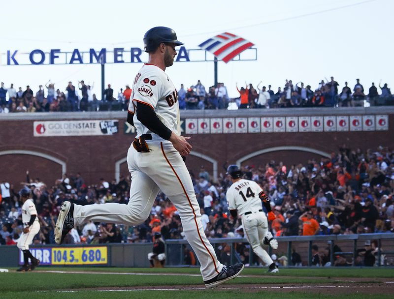 Aug 27, 2023; San Francisco, California, USA; San Francisco Giants center fielder Austin Slater (13) scores the first of three runs on an RBI double by catcher Patrick Bailey (14) during the fifth inning against the Atlanta Braves at Oracle Park. Mandatory Credit: Kelley L Cox-USA TODAY Sports