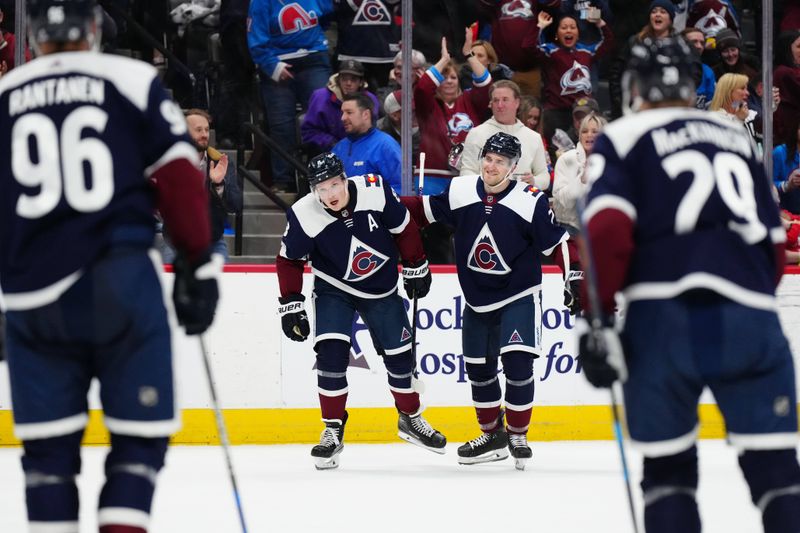 Mar 4, 2024; Denver, Colorado, USA; Colorado Avalanche defenseman Cale Makar (8) celebrates his goal scored with defenseman Devon Toews (7) in the second period against the Chicago Blackhawks at Ball Arena. Mandatory Credit: Ron Chenoy-USA TODAY Sports