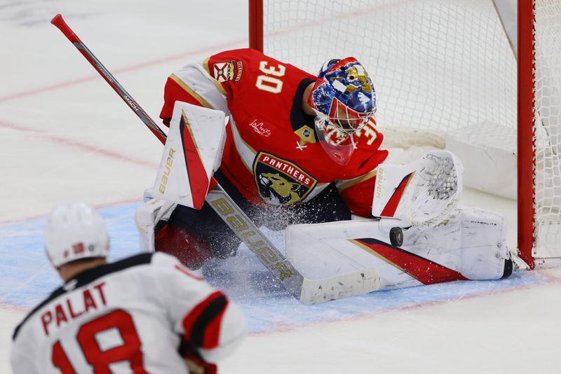 Nov 12, 2024; Sunrise, Florida, USA; Florida Panthers goaltender Spencer Knight (30) makes a save against New Jersey Devils left wing Ondrej Palat (18) during the third period at Amerant Bank Arena. Mandatory Credit: Sam Navarro-Imagn Images