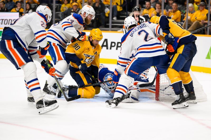 Oct 31, 2024; Nashville, Tennessee, USA;  Edmonton Oilers goaltender Calvin Pickard (30) blocks the shot of Nashville Predators center Jonathan Marchessault (81) during the third period at Bridgestone Arena. Mandatory Credit: Steve Roberts-Imagn Images