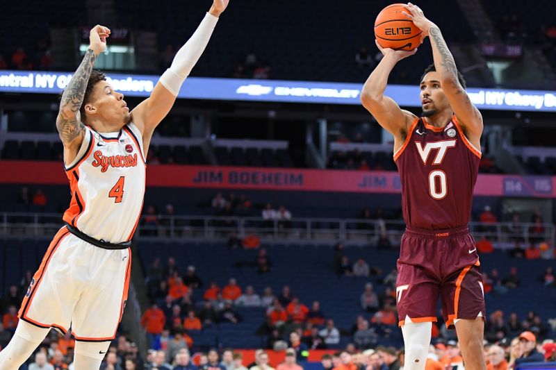 Jan 21, 2026; Syracuse, New York, USA; Virginia Tech Hokies guard Jailen Bedford (0) shoots against Syracuse Orange guard Nate Kingz (4) during the first half at the JMA Wireless Dome. Mandatory Credit: Rich Barnes-Imagn Images