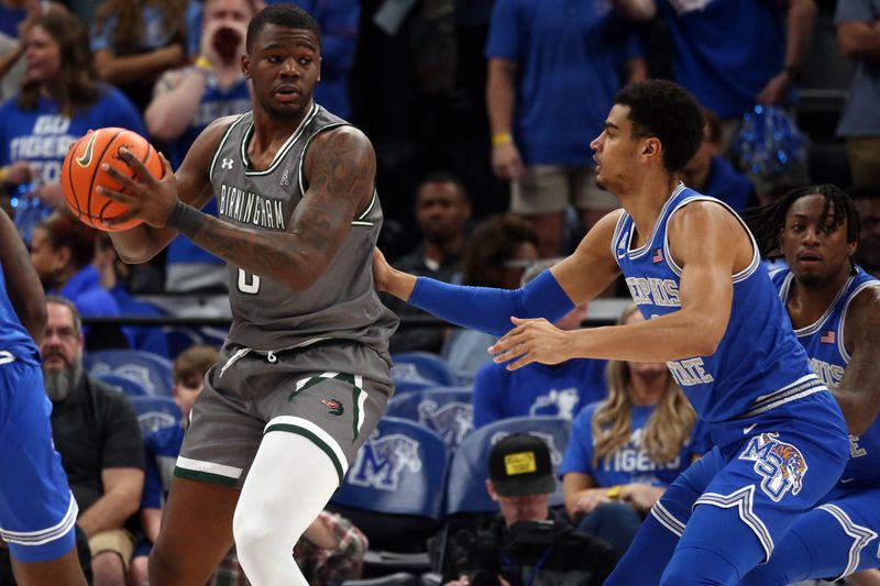 Mar 3, 2024; Memphis, Tennessee, USA; UAB Blazers forward Javian Davis (0) handles the ball as Memphis Tigers forward Nicholas Jourdain (2) defends during the first half at FedExForum. Mandatory Credit: Petre Thomas-USA TODAY Sports