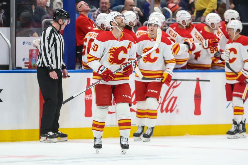 Feb 10, 2024; Elmont, New York, USA;  Calgary Flames center Jonathan Huberdeau (10) looks at the scoreboard after scoring a goal in the second period New York Islanders at UBS Arena. Mandatory Credit: Wendell Cruz-USA TODAY Sports